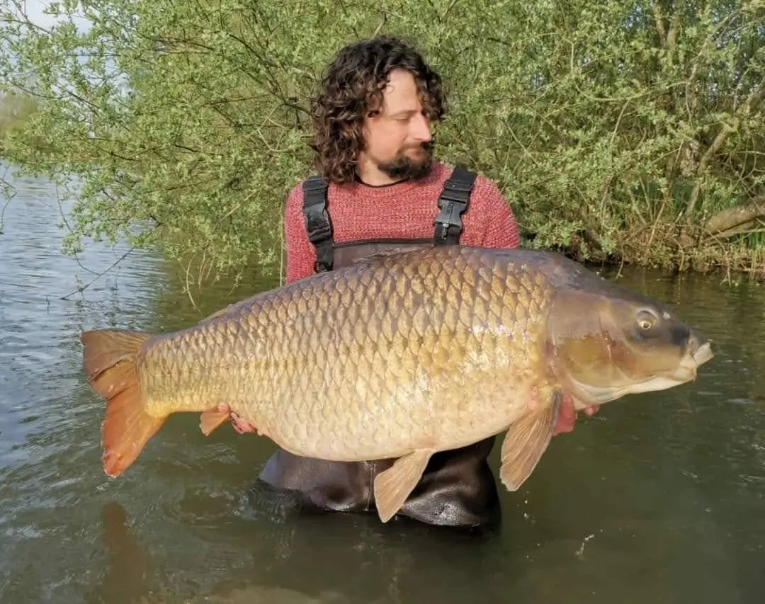 Angler with a carp caught on N.E Baits