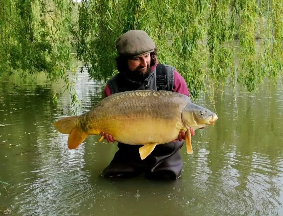 Angler with a carp caught on N.E Baits