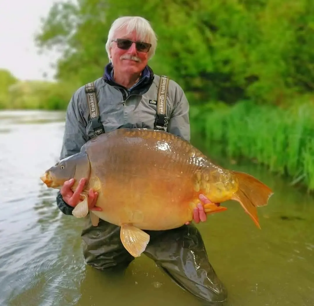Angler with a carp caught on N.E Baits
