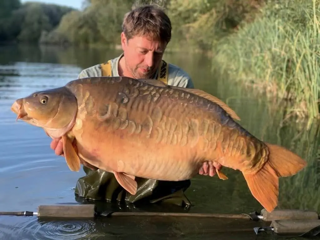 Angler with a carp caught on N.E Baits