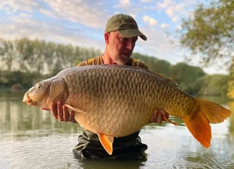 Angler with a carp caught on N.E Baits