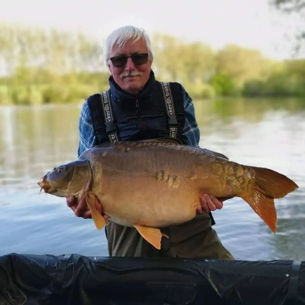 Angler with a carp caught on N.E Baits