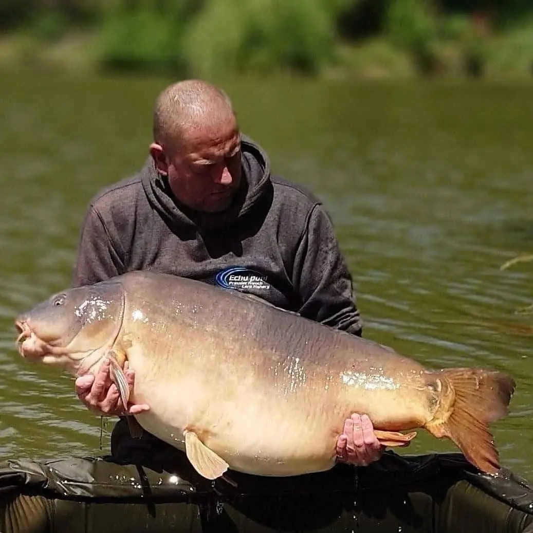 Angler with a carp caught on N.E Baits