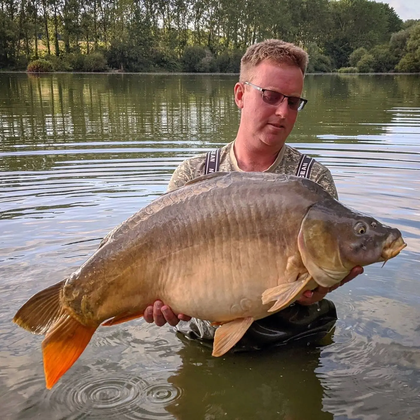 Angler with a carp caught on N.E Baits
