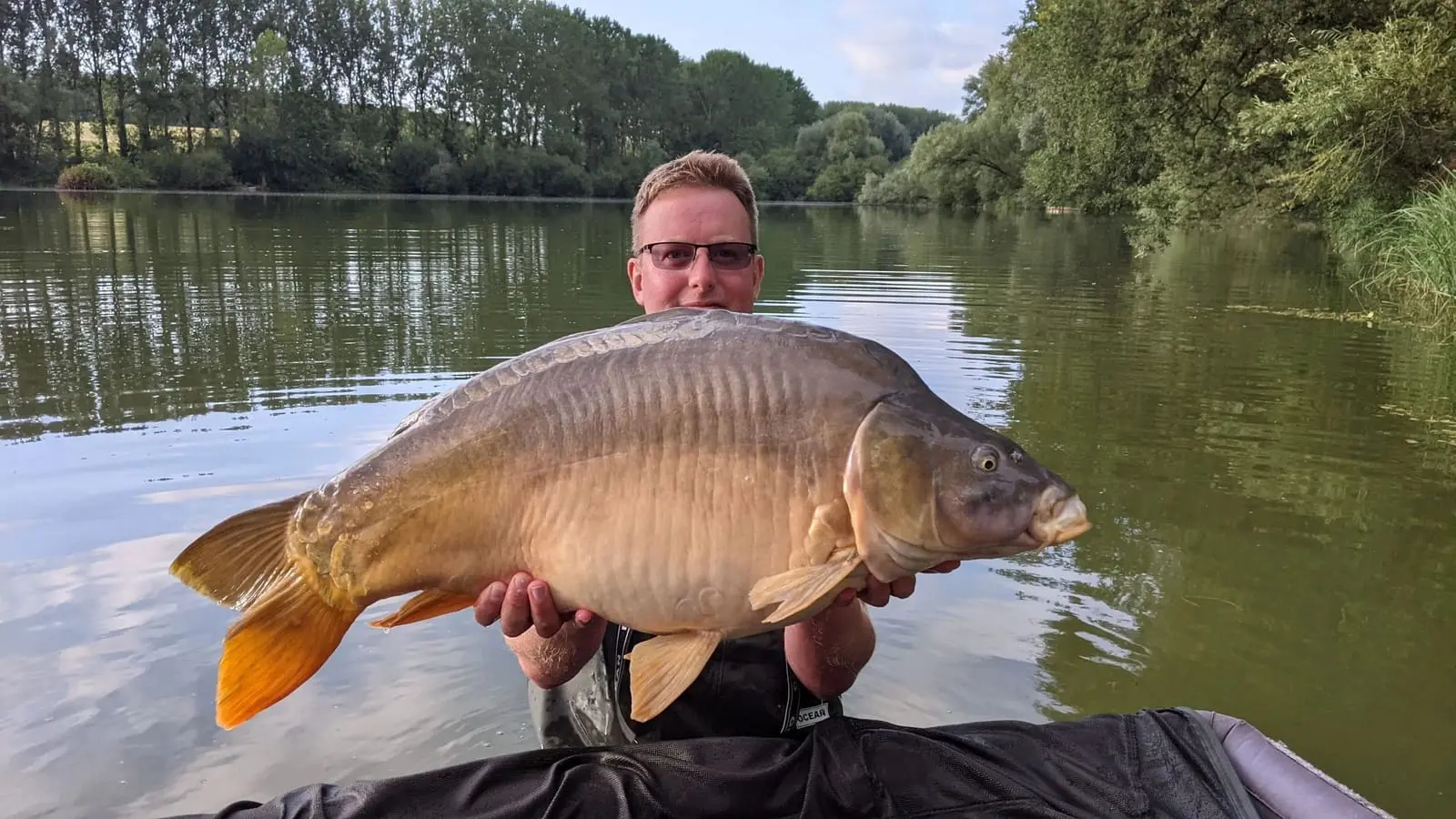 Angler with a carp caught on N.E Baits