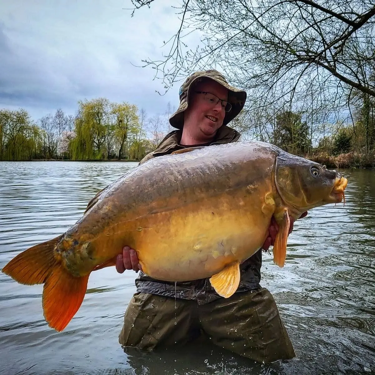Angler with a carp caught on N.E Baits