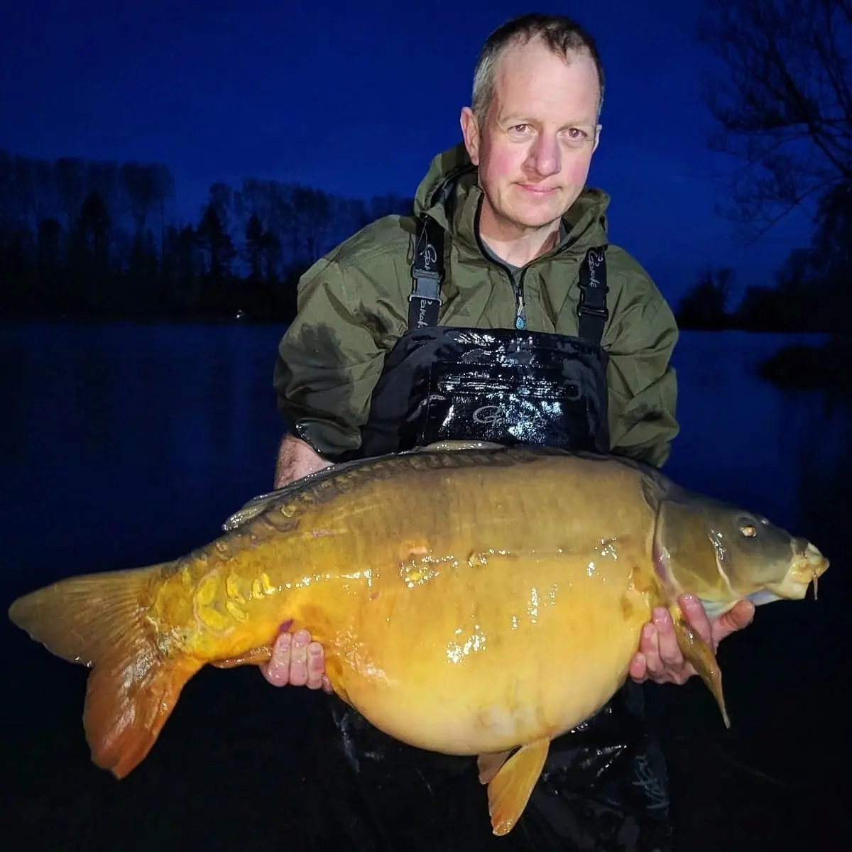 Angler with a carp caught on N.E Baits